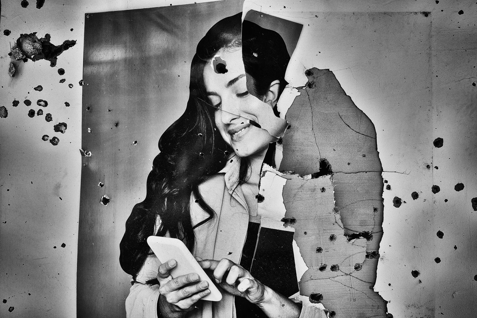 A bullet riddled phone advertisement.