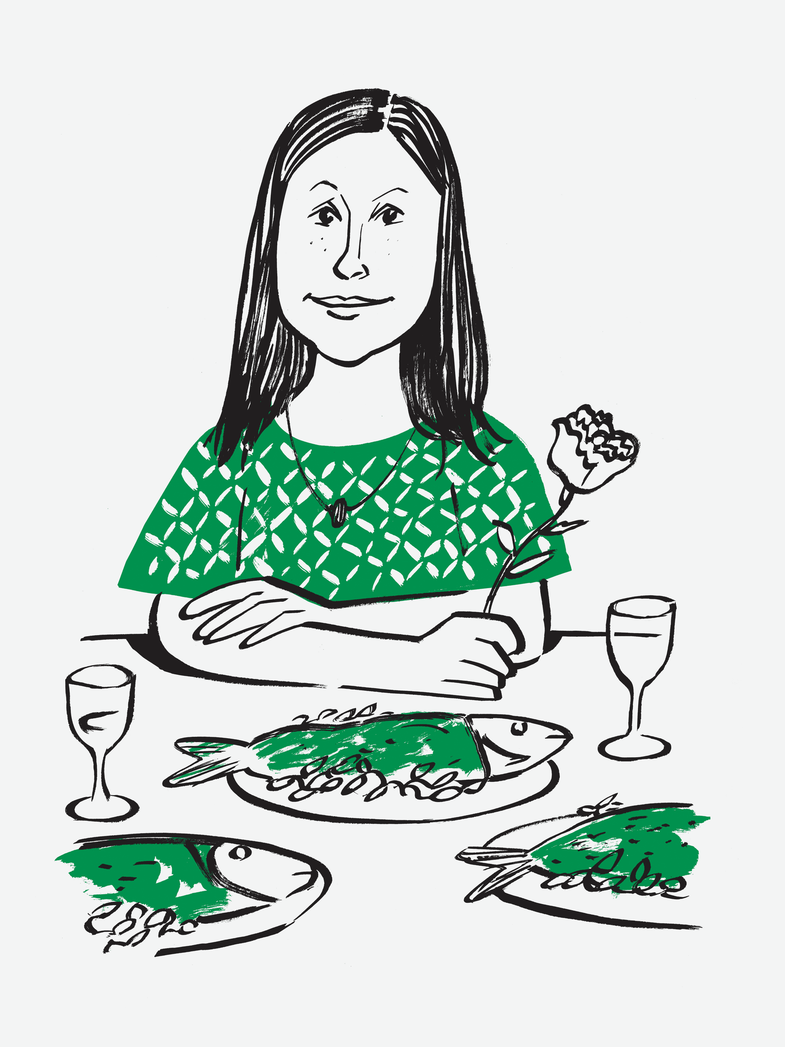 A woman with at a table with plates of fish and a rose.